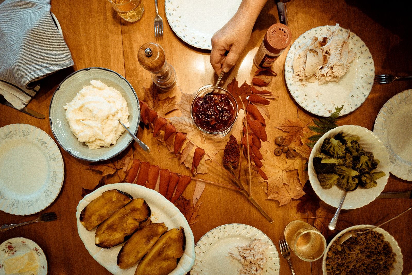 An overhead spread of Southern comfort food on a warm wooden table